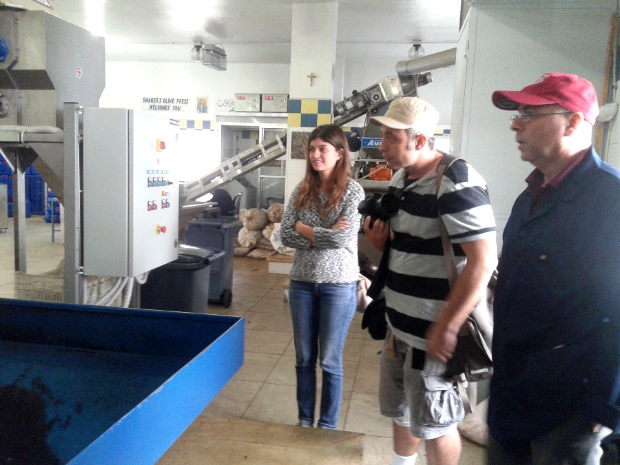 Bechara, on the right, explaining to his visitors how olive oil is extracted